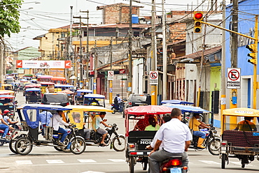 Mototaxis in a busy street in Iquitos, Peru, South America