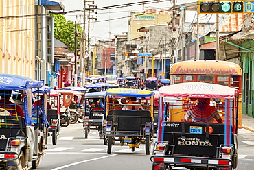 Mototaxis in a busy street in Iquitos, Peru, South America