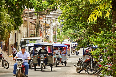 Mototaxis in a busy street in Iquitos, Peru, South America