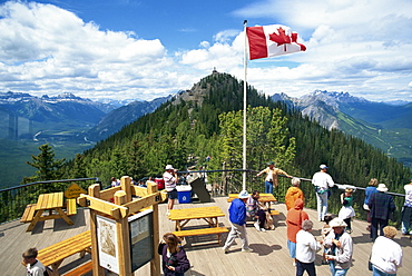 Tourists beneath the Canadian flag on Sulphur Mountain in the Banff National Park in Alberta, UNESCO World Heritage Site, Canada, North America