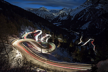 Car lights on the curvy Maloja Pass road at night, Maloja Pass, Engadine, Province of Graubunden, Switzerland, Europe