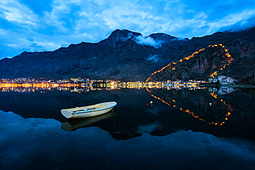 The Old Town (stari grad) and fortress of Kotor reflected in Kotor Bay, UNESCO World Heritage Site, Montenegro, Europe