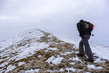 Hiker on Monte Catria in winter, Apennines, Umbria, Italy, Europe