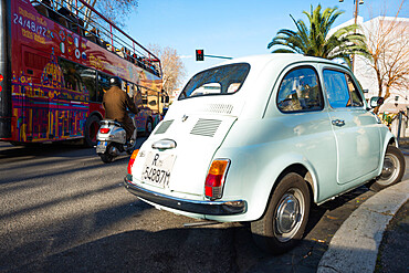 Rome traffic with classic Fiat 500 car, scooter and tourist bus, seen on city street, Rome, Lazio, Italy, Europe