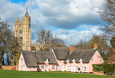 The village green in Cavendish with the medieval St. Mary church tower and traditional pink thatched cottages, Cavendish, Suffolk, England, United Kingdom, Europe