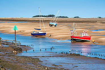 Colourful boats on sandbanks low tide, East Fleet river estuary, Wells next the sea, North Norfolk coast, Norfolk, East Anglia, England, United Kingdom, Europe