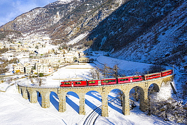 Bernina Express passes over the helical (spiral) viaduct of Brusio, UNESCO World Heritage Site, Valposchiavo, Canton of Graubunden, Switzerland, Europe