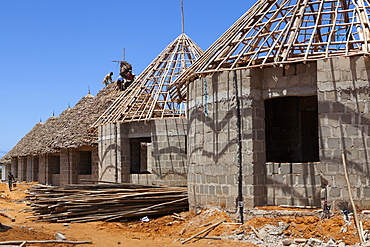 Men thatching the roofs of new houses, Mtwara, Tanzania, East Africa, Africa