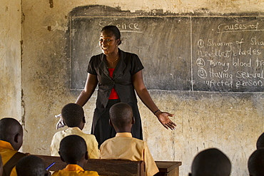 A female teacher teaching science to a classroom of students at a primary school, Ghana, West Africa, Africa