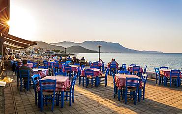 Restaurant at Paraliaki promenade at sunset in Kissamos, Crete, Greek Islands, Greece, Europe