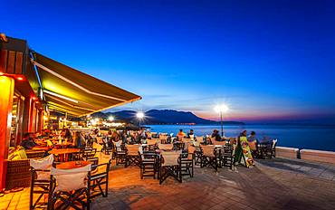 Traditional Cretan Food Restaurant at Paraliaki promenade at sunset in Kissamos, Crete, Greek Islands, Greece, Europe