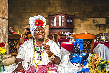 Cuban woman posing for photos while smoking big Cuban cigar in La Habana, (Havana), Cuba, West Indies, Caribbean, Central America