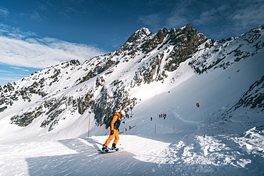 Snowboarder going down the slope at La Plagne ski resort, Tarentaise, Savoy, French Alps, France, Europe