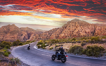 Motocycles driving through The Red Rock Canyon National Recreation Area at sunset, Las Vegas, Nevada, United States of America, North America