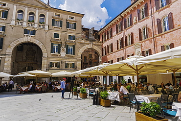 Piazza dei Signori, with crowd eating at restaurants in front of Palazzo Domus Nova on left and Casa della Pieta on right, Verona, Veneto, Italy, Europe