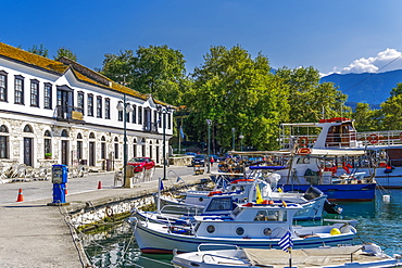 Day view of Limenas town with green vegetation, traditional house and moored ships, Thassos, Greek Islands, Greece, Europe