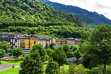 Day view of local buildings by a green hill in Andorra la Vella, capital of the Principality of Andorra, Europe