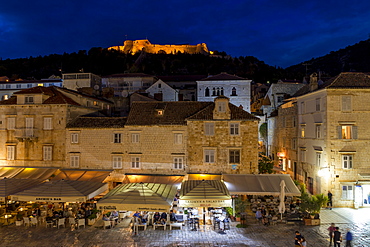 Elevated view over Svetog Stjepana square and the Spanish Fortress at night, Hvar, Croatia, Europe