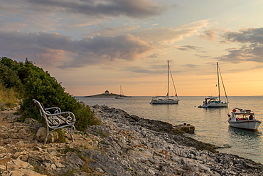 Boat anchoring at Pokonji Dol Beach near Hvar Town at sunset, Hvar, Croatia, Europe