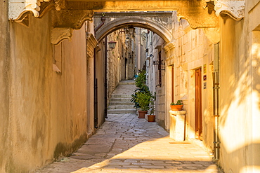 Narrow street inside the old town of Korcula at first sunlight, Korcula, Croatia, Europe