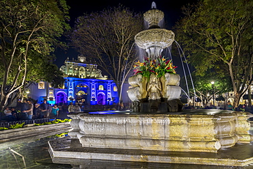 The fountain at the main square with view to the San Jose Cathedral during Holy Week, Antigua, Sacatepequez, Guatemala, Central America