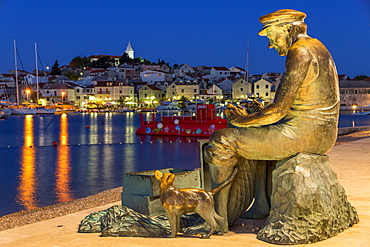 Fisherman statue with view to the old town of Primosten in the background, Croatia, Europe