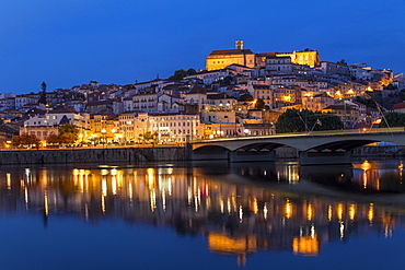 View from Mondego River to the old town with the university on top of the hill at dusk, Coimbra, Portugal, Europe