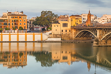 The Triana Neighbourhood seen from the banks of Guadalquivir River at first sunlight, Seville, Andalusia, Spain, Europe