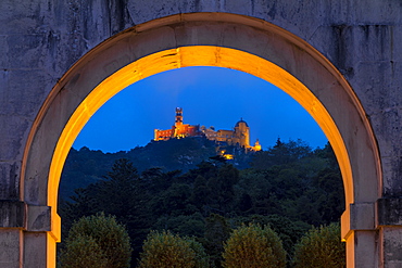 Illuminated Pena Palace seen from the Seteais Palace at dusk, UNESCO World Heritage Site, Sintra, Portugal, Europe