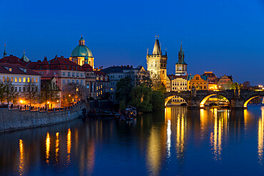 View over Charles Bridge, Old Town Bridge Tower and Vltava River at dusk, UNESCO World Heritage Site, Prague, Bohemia, Czech Republic, Europe