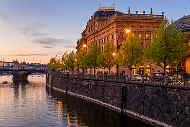 The National Theatre (Narodni divadlo) seen from the banks of Vltava River at dusk, Prague, Bohemia, Czech Republic, Europe