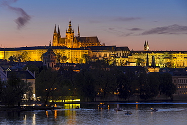 Illuminated Prague Castle and St. Vitus Cathedral seen from the banks of Vltava River, UNESCO World Heritage Site, Prague, Bohemia, Czech Republic, Europe