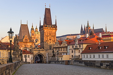 The Lesser Town Bridge Tower and St. Vitus Cathedral seen from Charles Bridge at first sunlight, UNESCO World Heritage Site, Prague, Bohemia, Czech Republic, Europe