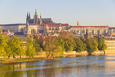 Prague Castle and St. Vitus Cathedral seen from the banks of Vltava River at first sunlight, UNESCO World Heritage Site, Prague, Bohemia, Czech Republic