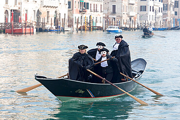 People in Venice Carnival costumes, rowing gondola on Grand Canal, Venice, UNESCO World Heritage Site, Veneto, Italy, Europe