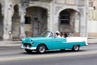 Turquoise vintage convertible American car driving along the Malecon in Havana, Cuba, West Indies, Caribbean, Central America