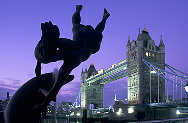 Girl with Dolphin fountain and Tower Bridge at dawn, London, England, United Kingdom, Europe