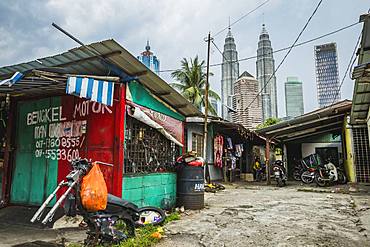 Side street in Kampung Baru with the Petronas Twin Towers in the background, Kuala Lumpur, Malaysia, Southeast Asia, Asia