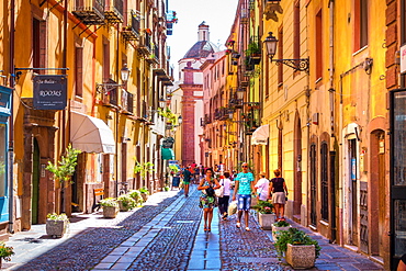 People walking along street in Bosa, Sardinia, Italy, Europe