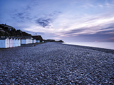 Twilight scene with beach huts and dew laden glistening pebbles on the beach at Budleigh Salterton, Devon, England, United Kingdom, Europe