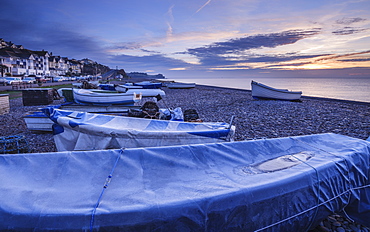 Serene dawn scene of fishing boats on the pebbled beach at Budleigh Salterton, Devon, England, United Kingdom, Europe