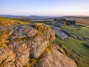 Warm sunlight on the granite summit of Saddle Tor in Dartmoor National Park, Bovey Tracey, Devon, England, United Kingdom, Europe