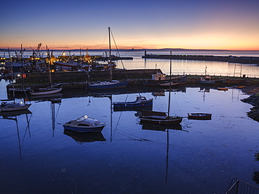 Sunrise looking across the inner and outer harbours at the fishing port of Newlyn, Cornwall, England, United Kingdom, Europe