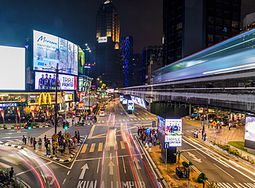 Night street scene in Bukit Bintang with a passing KL Monorail in Kuala Lumpur, Malaysia, Southeast Asia, Asia