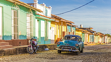 A classic car in a colourful colonial street in Trinidad, UNESCO World Heritage Site, Cuba, West Indies, Caribbean, Central America