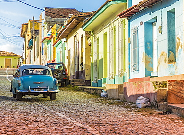 A car in a colourful colonial street in Trinidad, UNESCO World Heritage Site, Cuba, West Indies, Caribbean, Central America