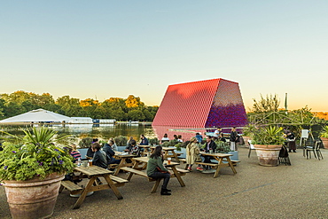 People relaxing in Hyde Park with The London Mastaba sculpture in the background, London, England, United Kingdom, Europe