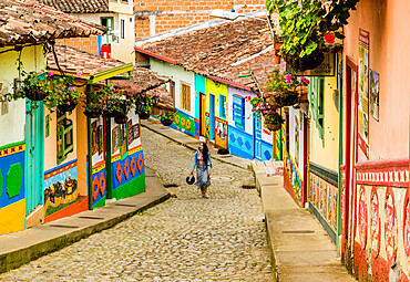 A typically colourful street with buildings covered in traditional local tiles in the picturesque town of Guatape, Colombia, South America