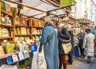 People at an antique book stall at Portobello Road market, in Notting Hill, London, England, United Kingdom, Europe