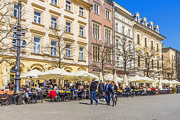 A cafe scene in the main square, Rynek Glowny, in the medieval old town, UNESCO World Heritage Site, Krakow, Poland, Europe